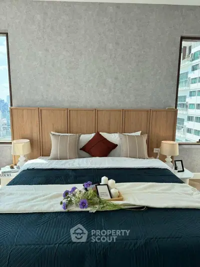 Luxurious bedroom with elegant decor and city view, featuring stylish bedding and modern design.