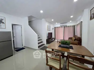 Spacious living and dining area with modern decor and natural light.