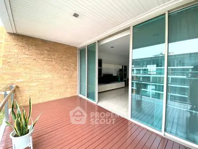 Spacious balcony with sliding glass doors and modern interior view