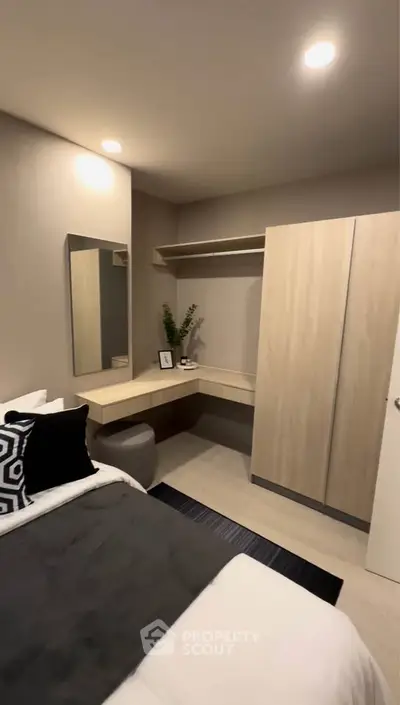 Modern bedroom with sleek design, featuring a built-in wardrobe and stylish decor, perfect for urban living.