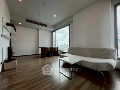 Modern living room with city view, sleek furniture, and wooden flooring.