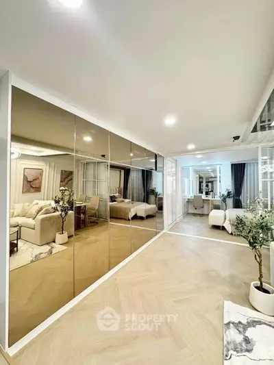 Spacious modern living room with mirrored walls and elegant decor