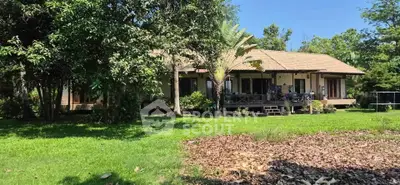 Charming single-story home with lush garden and spacious lawn, perfect for nature lovers.