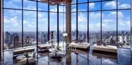 Luxurious high-rise living room with panoramic city views and modern furnishings.
