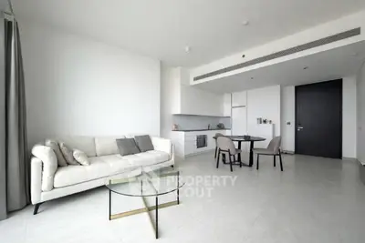 Modern open-plan living room with sleek kitchen and stylish furniture