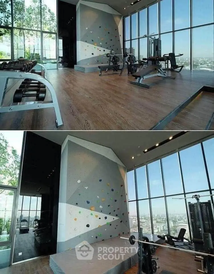 Luxurious gym with climbing wall and panoramic city views in modern high-rise building.