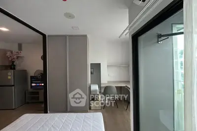 Modern bedroom with study area and balcony access in urban apartment