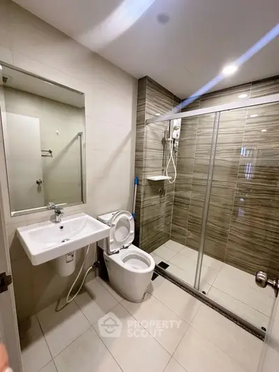 Modern bathroom with glass shower and sleek fixtures