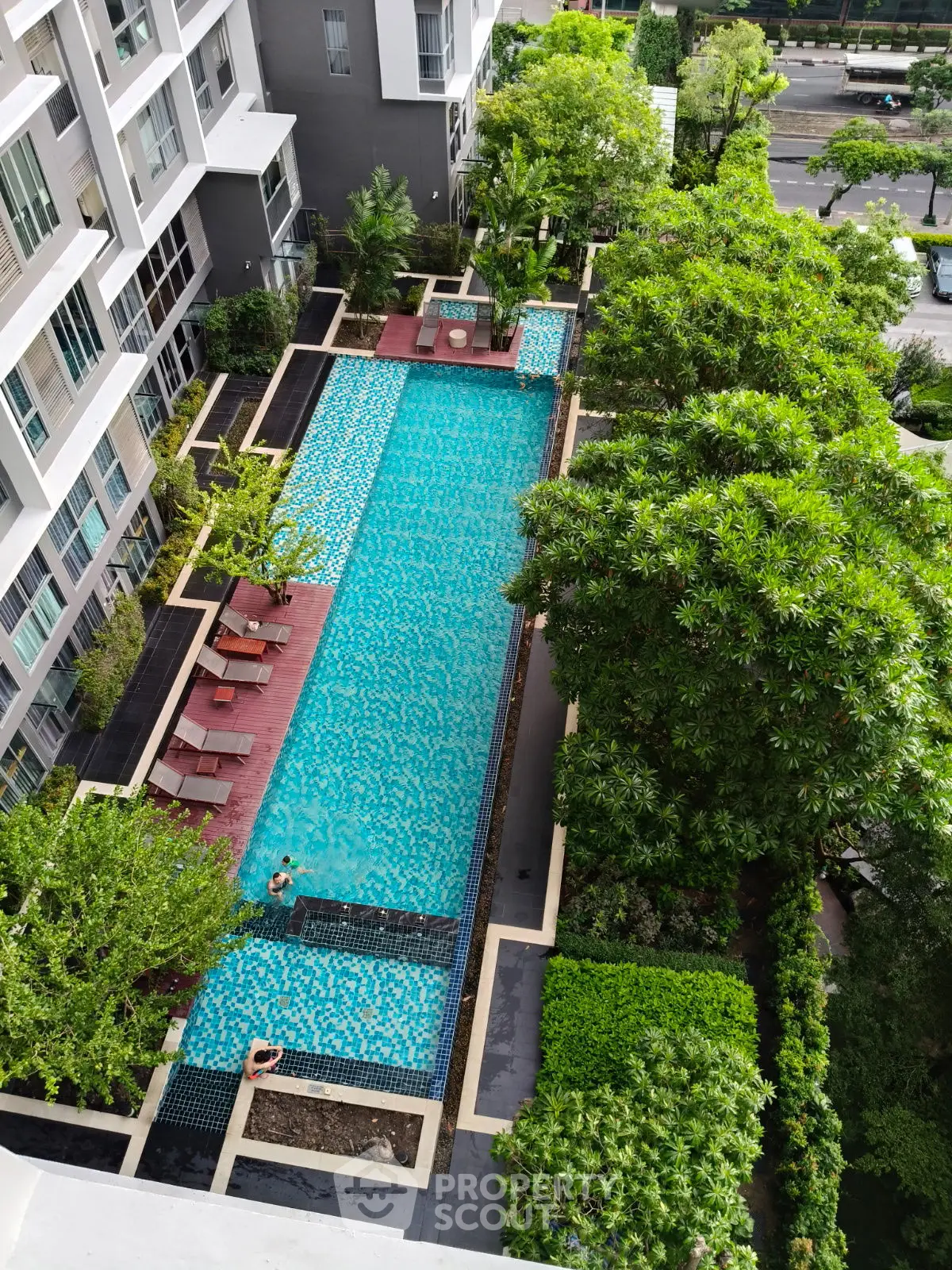 Luxurious condominium with stunning outdoor pool and lush greenery