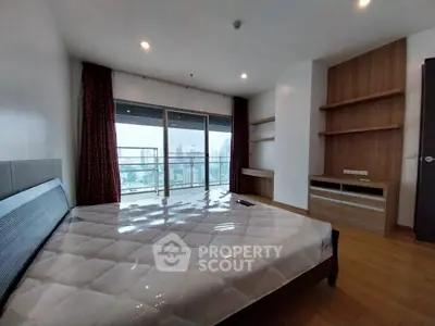 Spacious bedroom with city view and built-in shelves in modern apartment