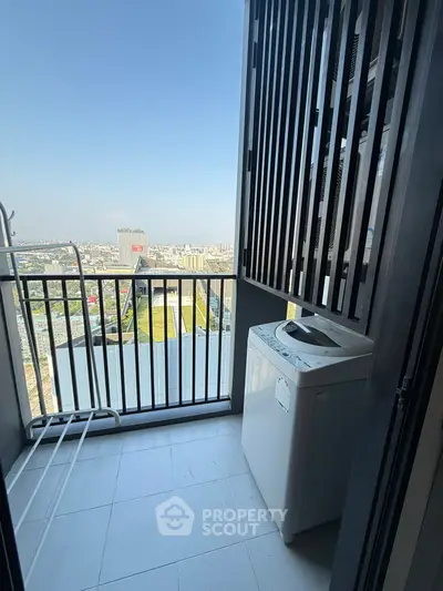 High-rise balcony with stunning city view and washing machine setup.