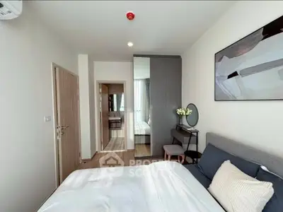 Modern bedroom with stylish decor and ample natural light, featuring a cozy bed and elegant furnishings.