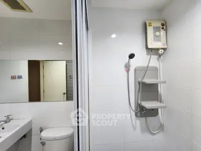 Modern bathroom with shower heater and sleek white tiles