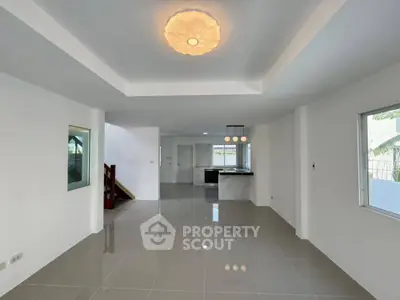 Spacious modern living area with open layout and elegant lighting