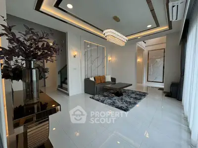 Luxurious modern living room with elegant chandelier and stylish decor