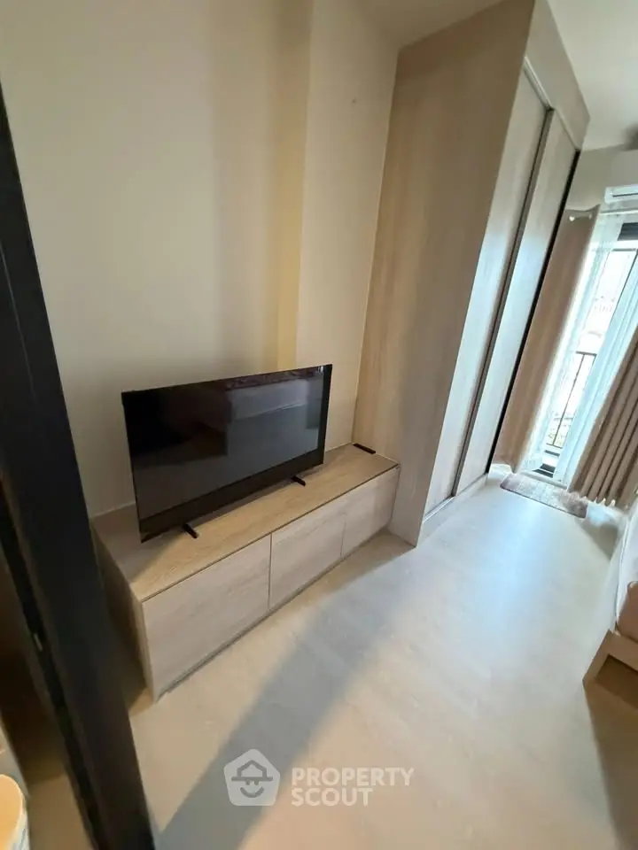 Modern living room with sleek TV stand and natural light