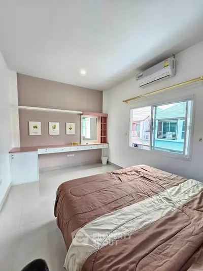 Spacious bedroom with modern decor and large window offering natural light.