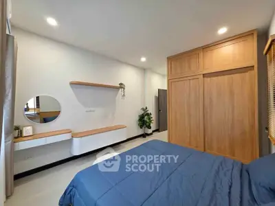 Modern bedroom with wooden wardrobe and stylish decor