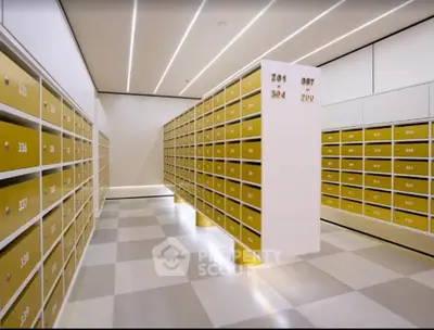 Modern mailroom with sleek gold mailboxes and checkered flooring