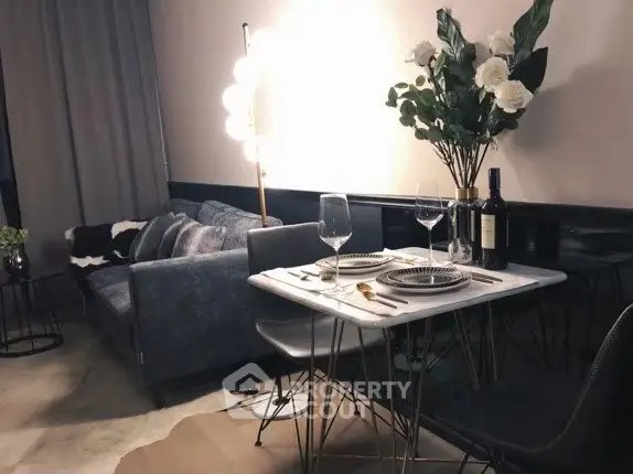 Stylish modern living room with cozy sofa and elegant dining setup, perfect for urban living.