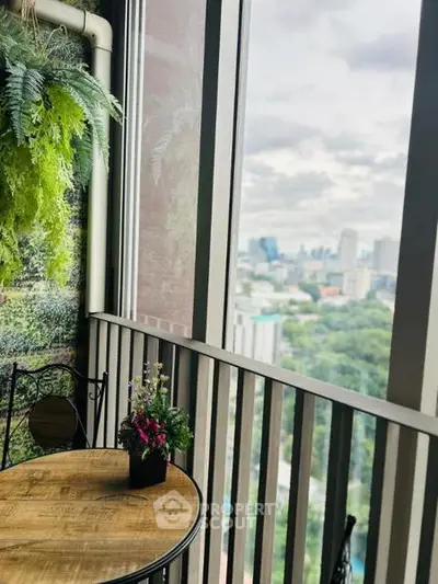 Charming balcony with city view and cozy seating area, perfect for relaxation.