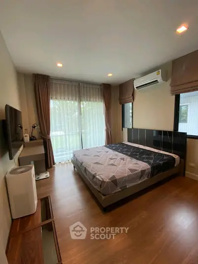 Modern bedroom with large windows and stylish decor