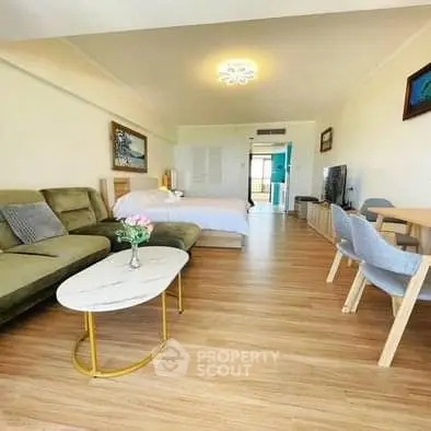 Spacious open-plan living room with modern decor and wooden flooring