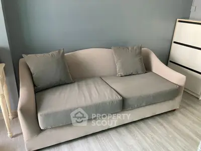 Modern living room with stylish gray sofa and minimalist decor