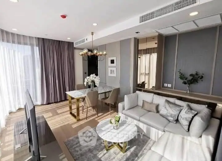 Luxurious modern living room with elegant decor and ample natural light.