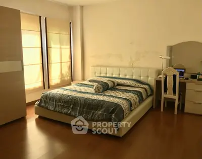Spacious bedroom with elegant decor and natural light