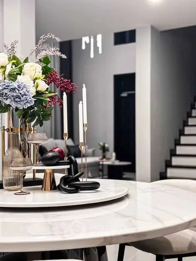 Elegant modern living room with stylish decor and staircase