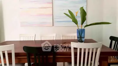 Elegant dining area with wooden table and modern art decor