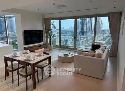 Spacious modern living room with city view, elegant furniture, and natural light.