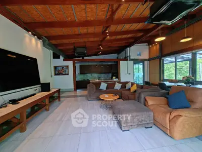 Spacious living room with modern decor and large windows offering natural light.