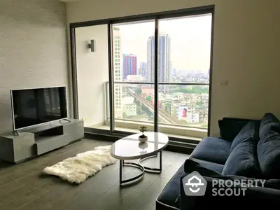 Spacious living room with large windows offering a panoramic city view, modern furnishings, and a cozy ambiance, perfect for urban living.