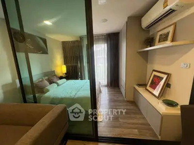 Modern bedroom with glass partition, cozy decor, and natural light.