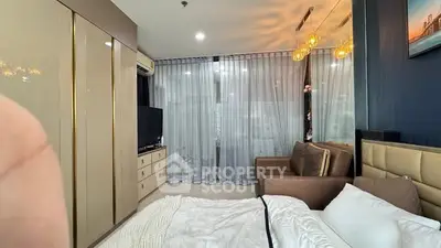 Luxurious bedroom with modern decor, large windows, and elegant lighting in a stylish apartment.