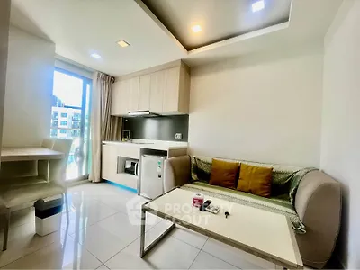 Modern living room with kitchenette and natural light in urban apartment