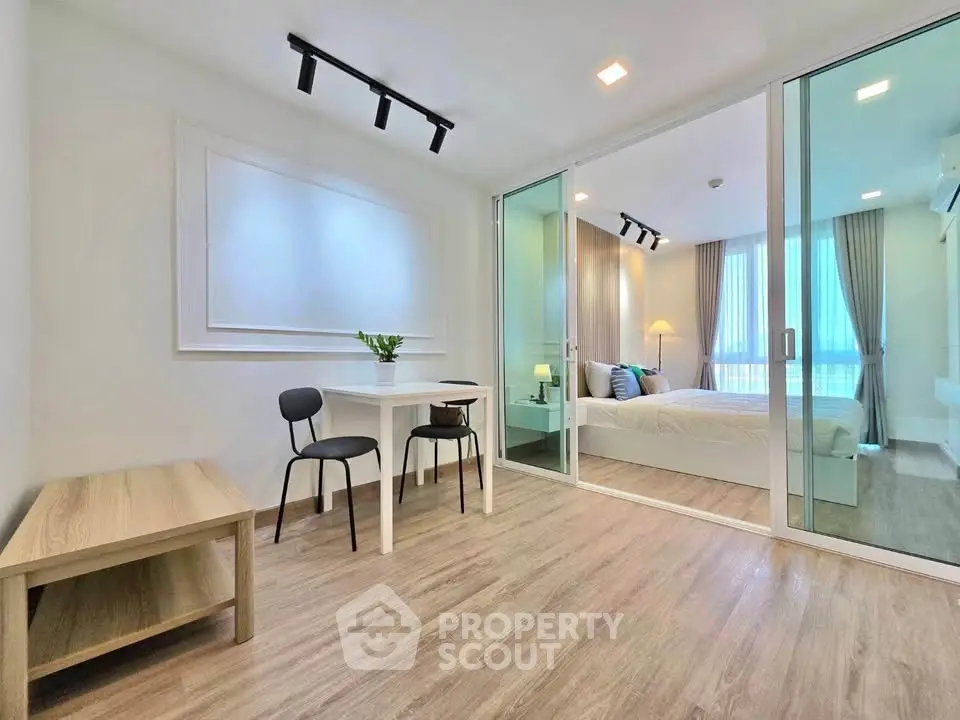 Modern apartment interior with open layout, featuring a cozy bedroom and stylish living area.