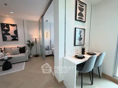 Modern living room with stylish decor and dining area in a contemporary apartment.