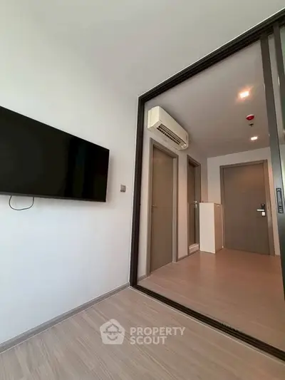 Modern apartment interior with sleek flooring and wall-mounted TV