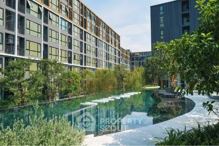 Modern apartment complex with lush greenery and a serene swimming pool