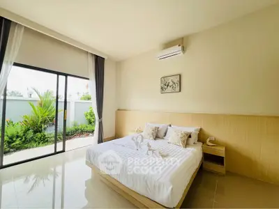Spacious bedroom with large window and garden view, featuring modern decor and air conditioning.