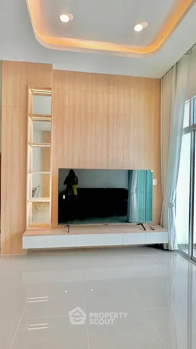 Modern living room with sleek TV setup and elegant lighting