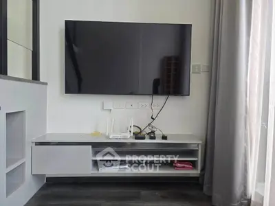 Modern living room with wall-mounted TV and sleek storage unit