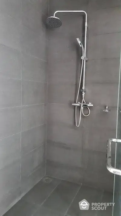 Modern bathroom with sleek shower design and dark tile finish