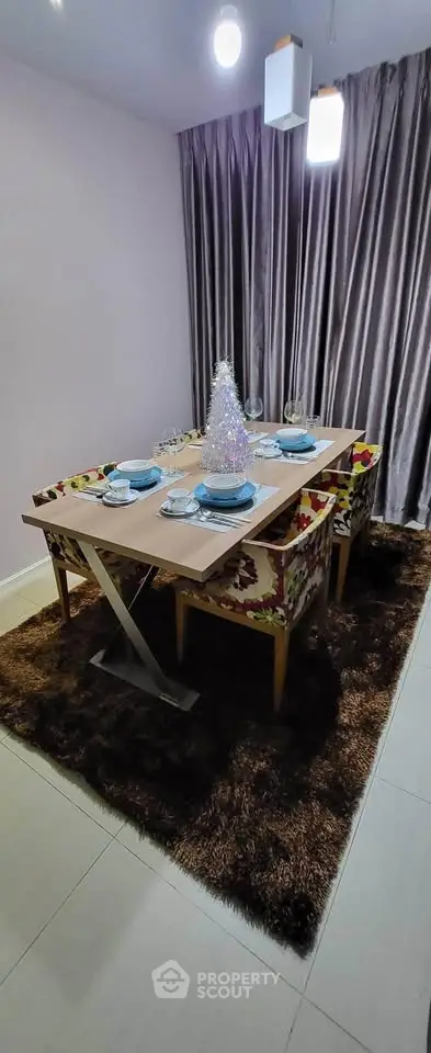 Elegant dining room with modern table setting and plush carpet, perfect for stylish gatherings.