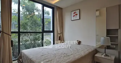 Cozy bedroom with large window and modern decor in a serene setting