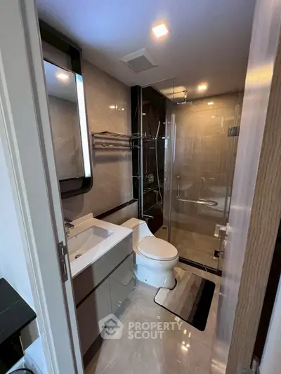 Modern bathroom with sleek fixtures and glass shower enclosure
