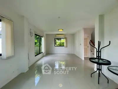 Spacious unfurnished living room with large windows and glossy tile flooring